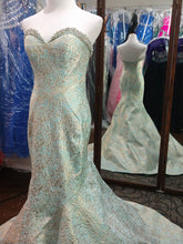 Load image into Gallery viewer, Mac Duggal 66740M Size 6 Aqua ice blue formal dress features a mermaid silhouette in jacquard, with beading accent on the collared strapless sweetheart neckline. The semi-open back is offset with a chapel train. Mermaid style gown, strapless sweetheart neckline, brocade has gold shine, dramatic train , zipper closure