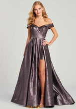 Load image into Gallery viewer, Colette #CL12003 Size 10 Amethyst, Prom dress, Formal, Hi Lo gown, Dazzling the crowd with this a line silhouette Colette dress style CL12003 for your upcoming social occasion. This amazing dress features an off the shoulder neckline that is paired with cap sleeves. This lovely gown showcases a dramatic glittery lame over lay skirt and a flattering rhinestone beaded belt that is perfect at the waist you will have an unforgettable night in this gorgeous gown! Back Zipper Detail ;Overskirt, Slit, Train