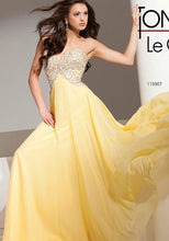 Load image into Gallery viewer, Tony Bowls TON115507 Prom gown has an A-Line style with Empire waist, strapless, chiffon overlay, fully beaded bodice, fully lined , Zipper closure. yellow
