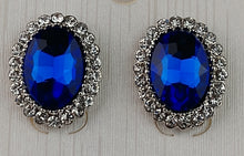 Load image into Gallery viewer, Ashley Collections post earrings ; Post/stud style earrings, oval shape, blue Sapphire stone with faucet cuts adding more sparkle , crystal rhinestone trim ; made in china 
