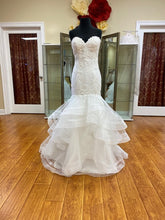 Load image into Gallery viewer, Adagio Bridal ivory wedding gown Size 6 Style : W9233 This mermaid , fit n flare gown has a lace and beaded detailed bodice ,corset back. The skirt is a full layered skirt lined with a horsehair trim, chapel length train.
